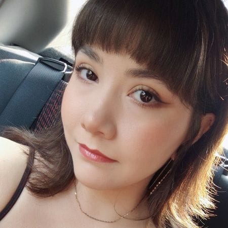 michelle Young woman with brown hair and winged eyeliner, sitting in a car and looking at the camera in a stunning Ceemi Agency portrait.